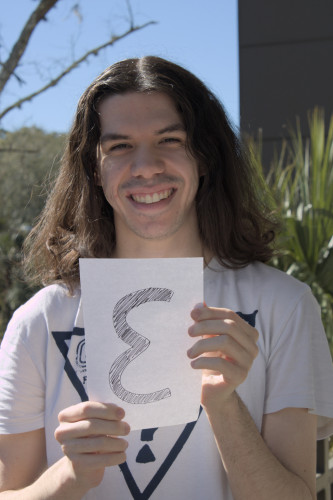 Picture of Joshua holding the letter E.