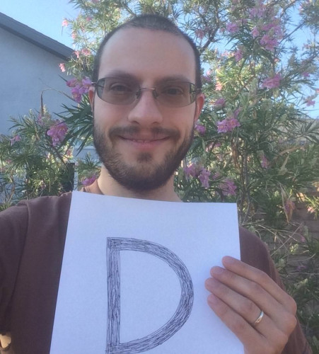 Picture of Nate Graham holding the letter D.