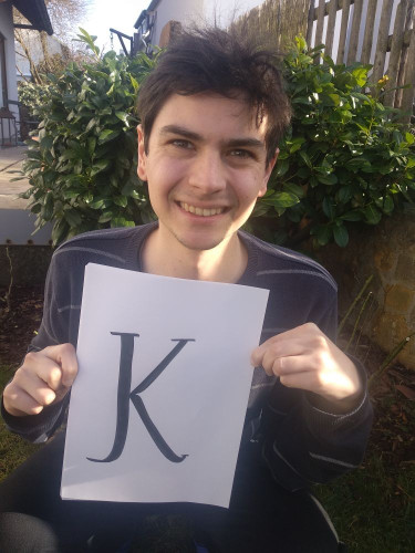 David Redondo holding the letter K