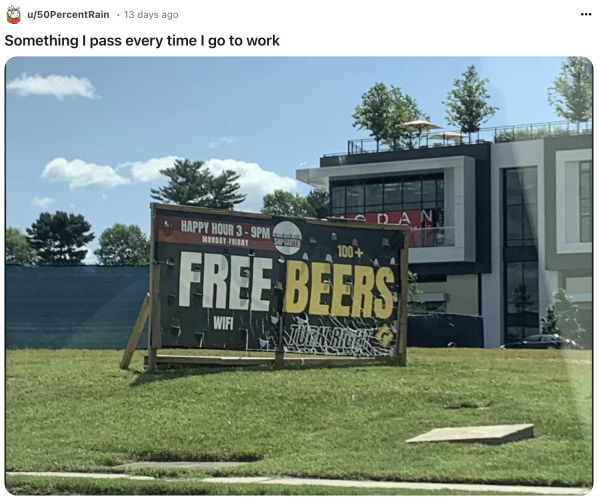 A sign on the side of the road that looks like it says "Free Beers," but actually means to advertise "Free wifi, 100+ beers"